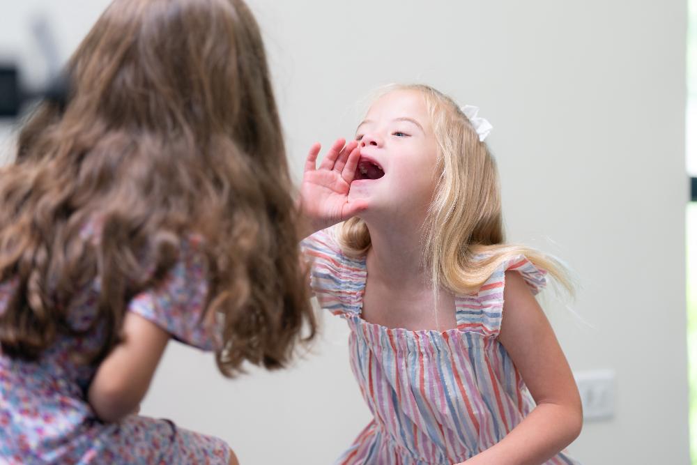 Blonde special needs girl opening her mouth